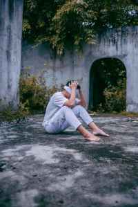 photo of man sitting on ground