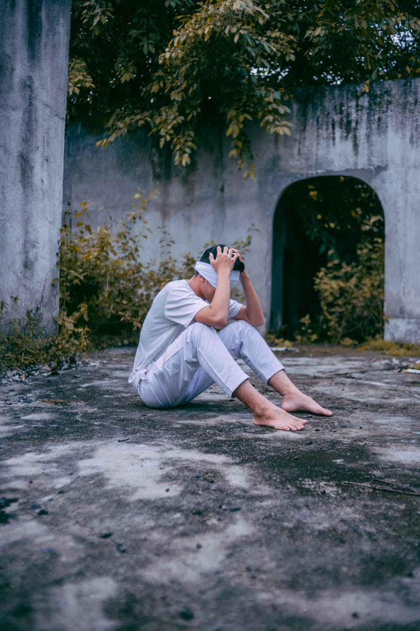 man sitting with head in hands