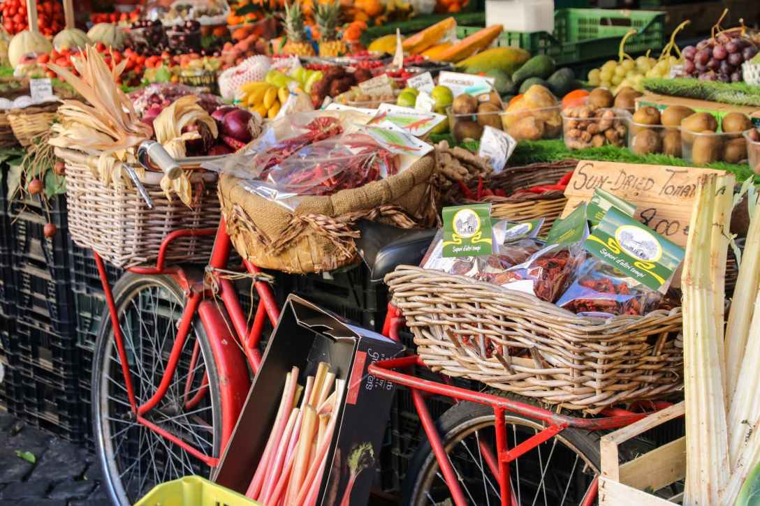 assorted fruits and vegetables in baskets for sale in the fruit market
