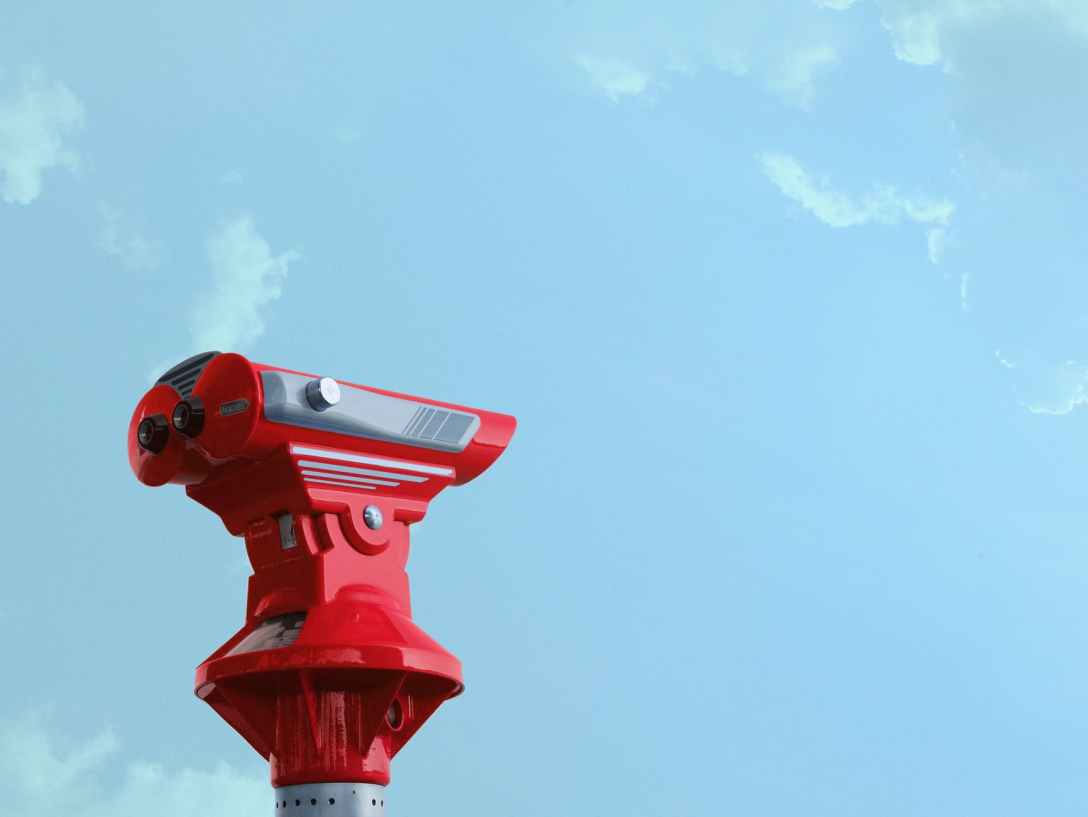 tourist binoculars against a blue sky